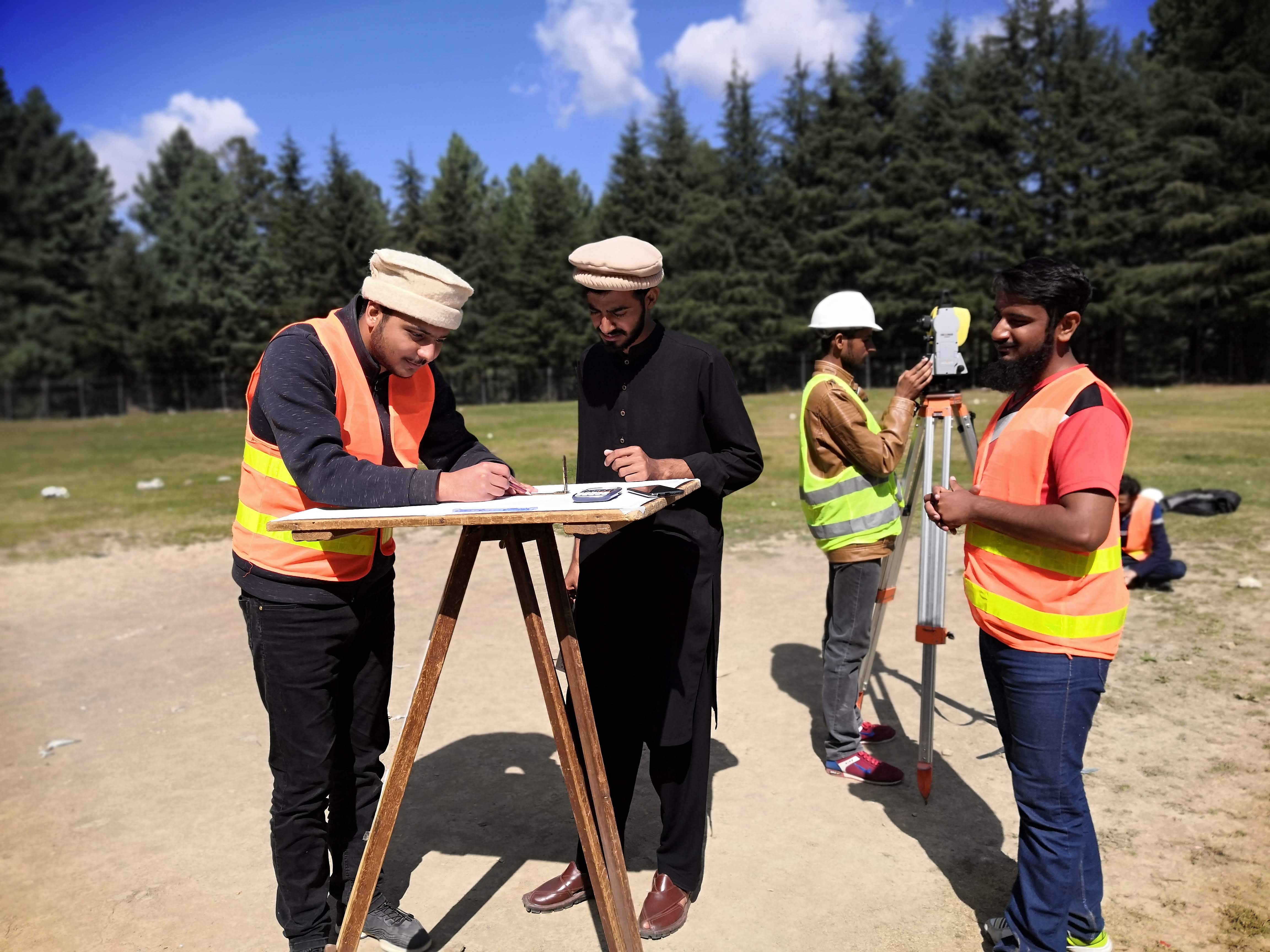 Naqsha Wala team members working on-site with surveying equipment and architectural plans